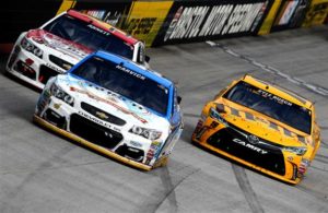 Kevin Harvick leads a pack of cars during the Bass Pro Shops NRA Night Race at Bristol Motor Speedway. [Photo by Brian Lawdermilk/Getty Images]