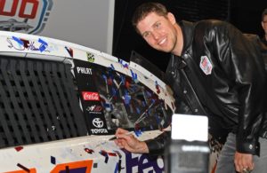 Denny Hamlin and all crew members took turns autographing winning car. [Joe Jennings Photo]