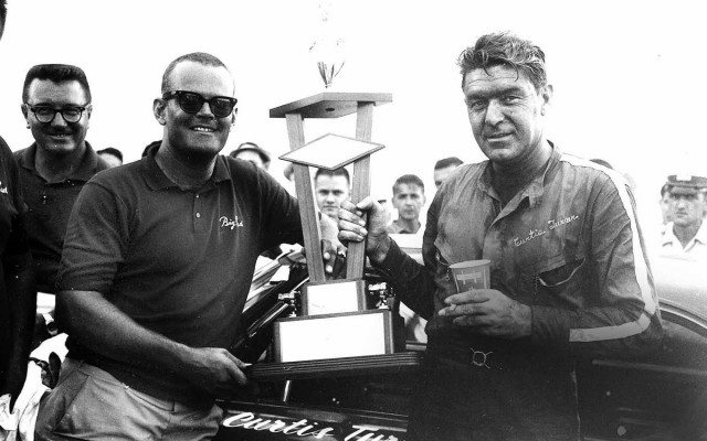 Curtis Turner in victory lane after winning the shortened USAC Stock Car race at Meadowdale. Turner drove on the USAC Stock Car circuit while on suspension from NASCAR after trying to unionize the series. [Photo by Russ Lake]