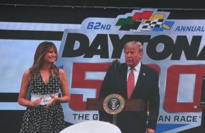 President Donald Trump and Melania Trump take to the stage for remarks prior to start of Daytona 500. [Joe Jennings Photo]