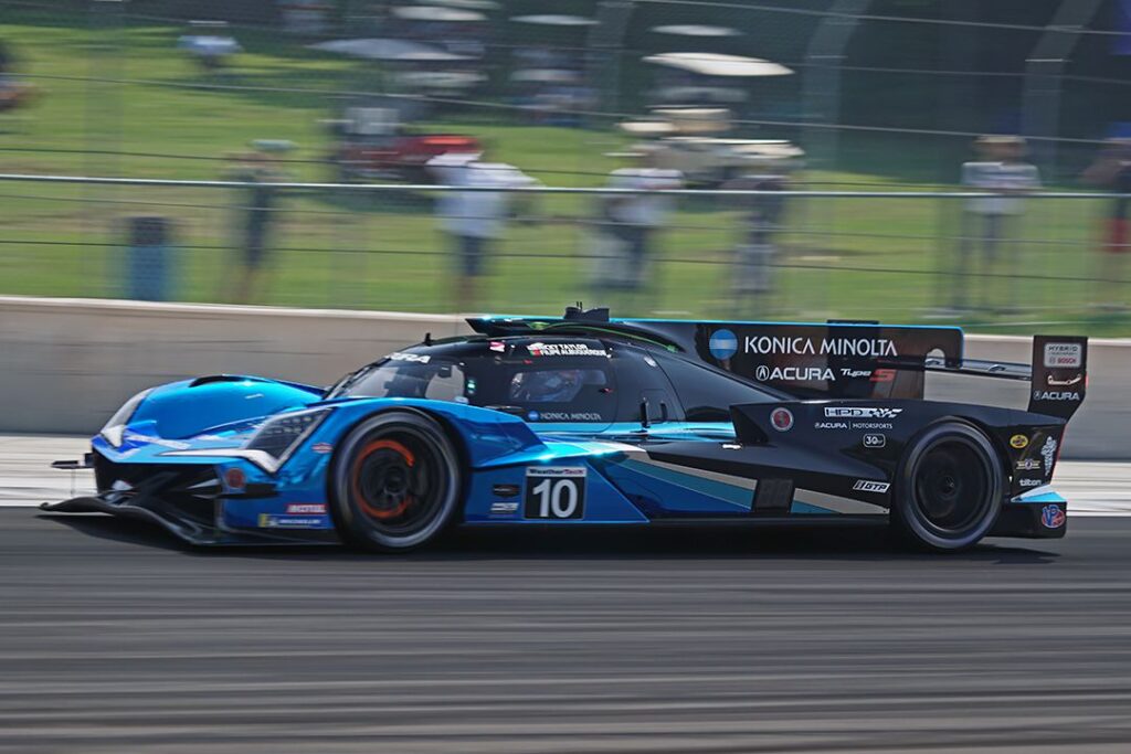 The current Acura GTP heats up the front brakes on the way into T5 during Friday practice. Notice the extra length compared to last year’s car. [Pete Gorski Photo]